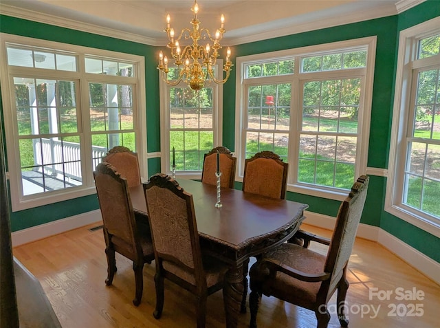 6301 Hawk Nest Dr, Concord, NC 28027 - dining room with ornamental molding, a chandelier, and light wood-style flooring