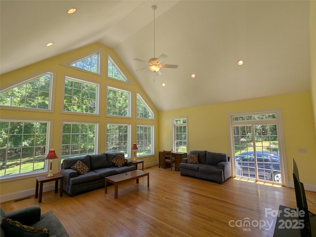 6301 Hawk Nest Dr, Concord, NC 28027 - living area with healthy amount of natural light, high vaulted ceiling, wood finished floors, ceiling fan, and recessed lighting