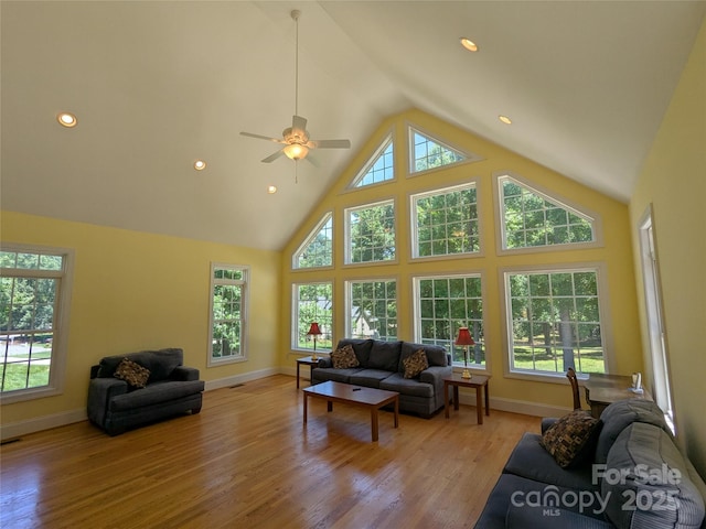 6301 Hawk Nest Dr, Concord, NC 28027 - living room with high vaulted ceiling, light wood-style floors, ceiling fan, and recessed lighting