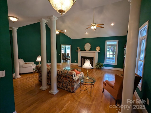 6301 Hawk Nest Dr, Concord, NC 28027 - living room featuring decorative columns, ceiling fan, wood finished floors, vaulted ceiling, and a fireplace