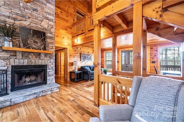 1818 W Paradise Harbor Dr Unit 172, Connelly Springs, NC 28612 - living area with wood walls, wood finished floors, a fireplace, high vaulted ceiling, and a wooden ceiling with exposed beams