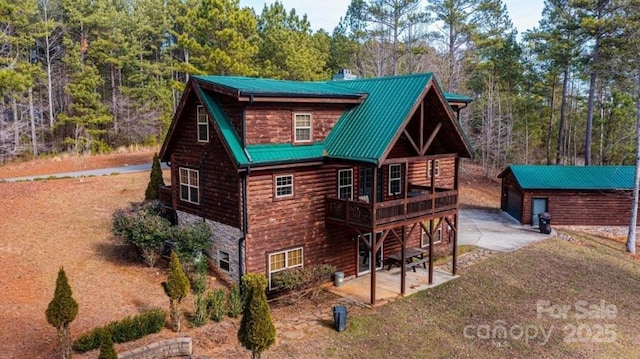 1818 W Paradise Harbor Dr Unit 172, Connelly Springs, NC 28612 - view of front of property featuring an outbuilding, a wooden deck, a chimney, a patio area, and a metal roof
