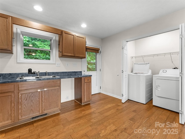 96 Habitat Way, Brevard, NC 28712 - kitchen with separate washer and dryer, dark countertops, light wood finished floors, brown cabinetry, and recessed lighting