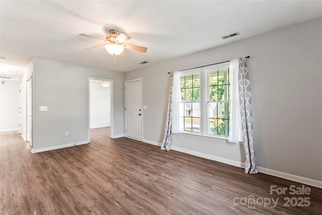 600 Piper Ct, Wingate, NC 28174 - empty room featuring a ceiling fan, wood finished floors, attic access, and a textured ceiling