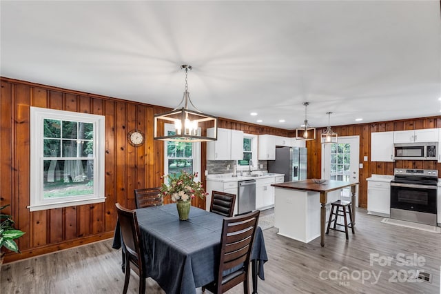 1641 Converse St, Lancaster, SC 29720 - dining space featuring light wood-style flooring, a chandelier, recessed lighting, and wooden walls