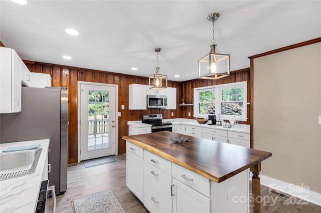 1641 Converse St, Lancaster, SC 29720 - kitchen with wood counters, appliances with stainless steel finishes, recessed lighting, wood walls, and white cabinetry