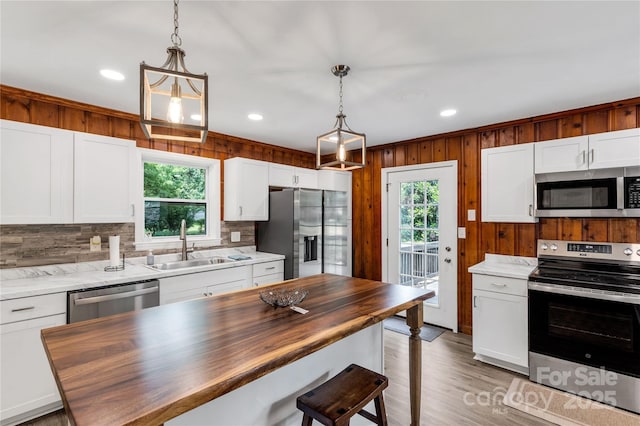 1641 Converse St, Lancaster, SC 29720 - kitchen featuring stainless steel appliances, wooden counters, healthy amount of natural light, a kitchen bar, and recessed lighting