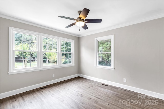 1641 Converse St, Lancaster, SC 29720 - empty room with healthy amount of natural light, crown molding, wood finished floors, and a ceiling fan