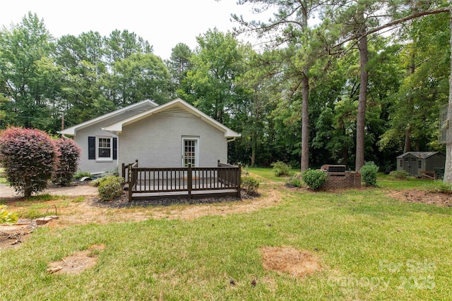 1641 Converse St, Lancaster, SC 29720 - view of green lawn with a storage shed, a wooden deck, and view of scattered trees