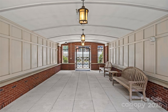 2810 Selwyn Ave Unit 429, Charlotte, NC 28209 - building lobby featuring brick wall and vaulted ceiling
