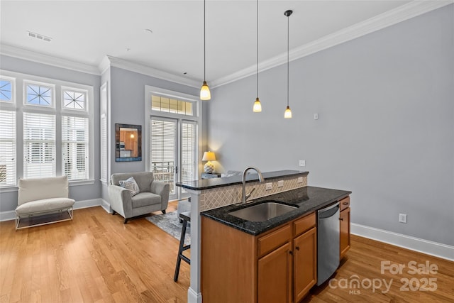 2810 Selwyn Ave Unit 429, Charlotte, NC 28209 - kitchen with stainless steel dishwasher, a kitchen breakfast bar, light wood finished floors, crown molding, and open floor plan