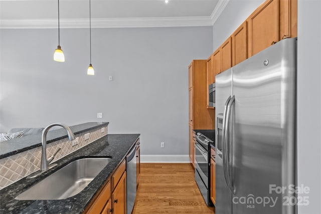 2810 Selwyn Ave Unit 429, Charlotte, NC 28209 - kitchen featuring appliances with stainless steel finishes, ornamental molding, light wood finished floors, brown cabinetry, and decorative light fixtures