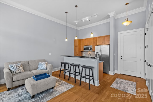 2810 Selwyn Ave Unit 429, Charlotte, NC 28209 - living area featuring crown molding, rail lighting, light wood finished floors, and a towering ceiling