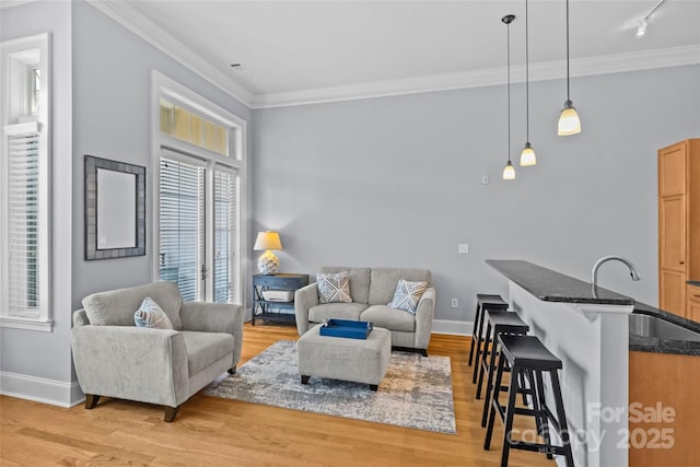 2810 Selwyn Ave Unit 429, Charlotte, NC 28209 - living room featuring crown molding, light wood-style flooring, and rail lighting