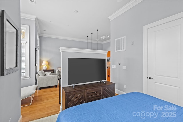 2810 Selwyn Ave Unit 429, Charlotte, NC 28209 - bedroom featuring multiple windows, ornamental molding, and wood finished floors