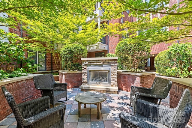 2810 Selwyn Ave Unit 429, Charlotte, NC 28209 - view of patio / terrace featuring an outdoor stone fireplace