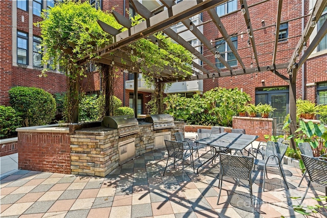 2810 Selwyn Ave Unit 429, Charlotte, NC 28209 - view of patio with exterior kitchen, outdoor dining area, and a pergola