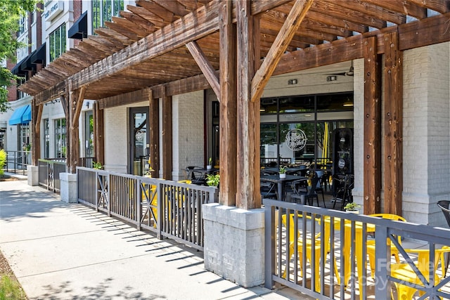 2810 Selwyn Ave Unit 429, Charlotte, NC 28209 - entrance to property featuring brick siding, a pergola, and covered porch