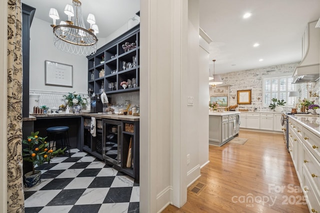 3519 Mcpherson St, Waxhaw, NC 28173 - bar with beverage cooler, recessed lighting, pendant lighting, a chandelier, and light wood-style flooring