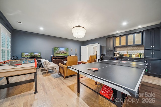 3519 Mcpherson St, Waxhaw, NC 28173 - game room featuring a chandelier, crown molding, light wood-style flooring, and recessed lighting