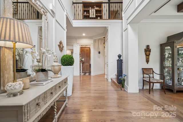 3519 Mcpherson St, Waxhaw, NC 28173 - foyer with light wood-type flooring, a towering ceiling, and crown molding