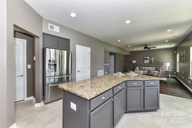 3533 Catherine Creek Pl, Davidson, NC 28036 - kitchen featuring stainless steel refrigerator with ice dispenser, a ceiling fan, light tile patterned flooring, a kitchen island, and open floor plan