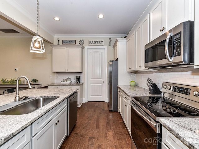 618 Deese Rd, Monroe, NC 28110 - kitchen with appliances with stainless steel finishes, ornamental molding, white cabinetry, decorative light fixtures, and recessed lighting