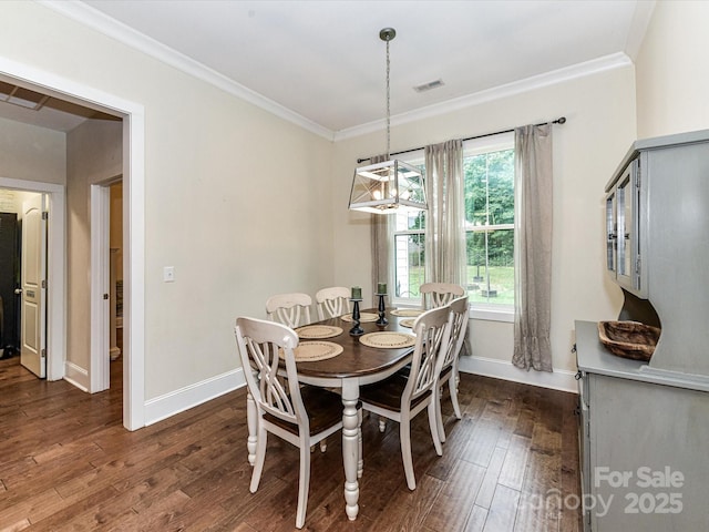 618 Deese Rd, Monroe, NC 28110 - dining room featuring dark wood-type flooring, crown molding, and a chandelier
