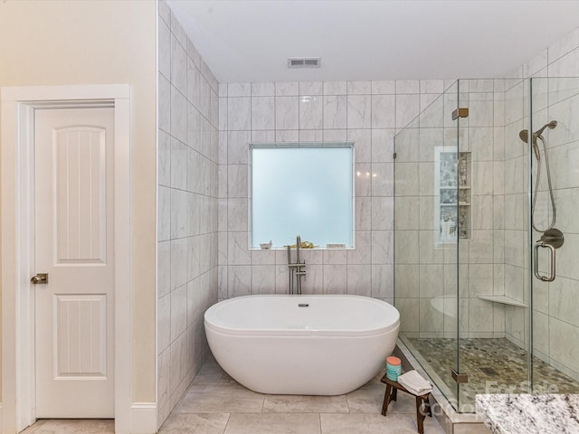 618 Deese Rd, Monroe, NC 28110 - bathroom with a stall shower, a soaking tub, tile walls, and tile patterned flooring