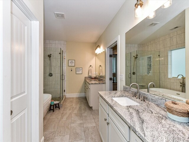 618 Deese Rd, Monroe, NC 28110 - bathroom with a stall shower, two vanities, a soaking tub, and marble look tiles