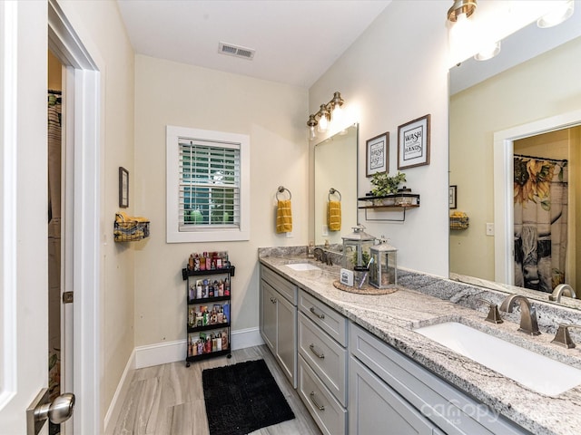 618 Deese Rd, Monroe, NC 28110 - full bathroom with double vanity and baseboards