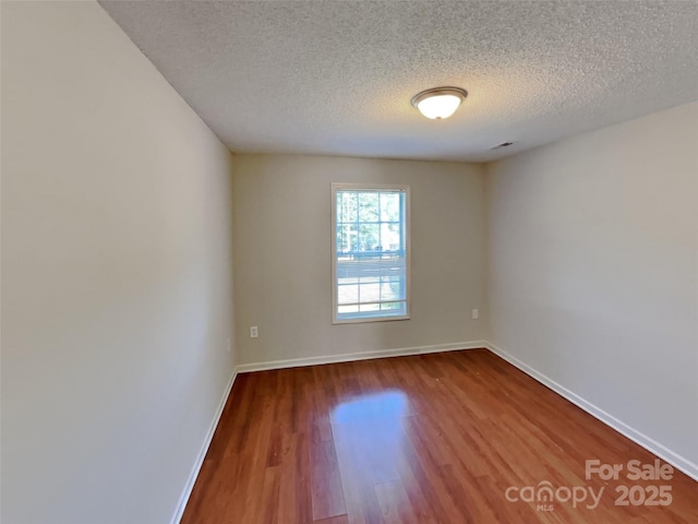 1108 Brookwood Dr, Stanley, NC 28164 - spare room with a textured ceiling and wood finished floors