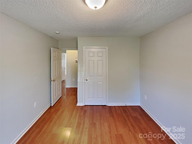 1108 Brookwood Dr, Stanley, NC 28164 - empty room featuring wood finished floors and a textured ceiling