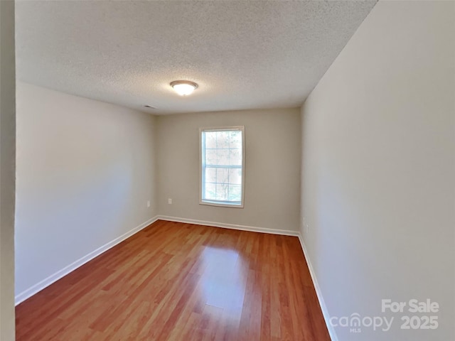 1108 Brookwood Dr, Stanley, NC 28164 - unfurnished room featuring a textured ceiling and wood finished floors