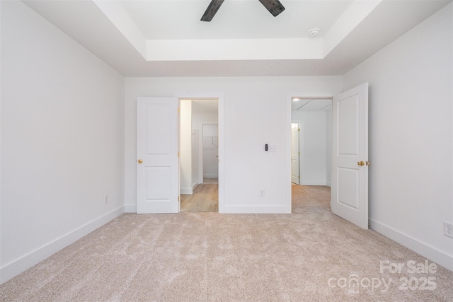 782 Stanley Spencer Mtn Rd, Gastonia, NC 28056 - unfurnished bedroom with a raised ceiling, light carpet, and a ceiling fan
