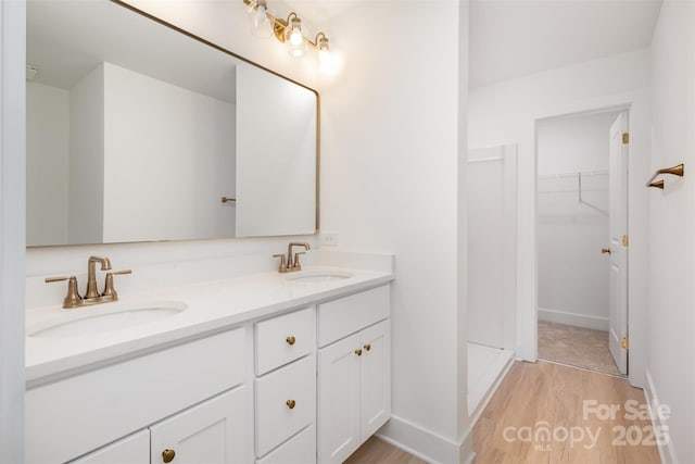 782 Stanley Spencer Mtn Rd, Gastonia, NC 28056 - bathroom featuring wood finished floors, double vanity, and a spacious closet