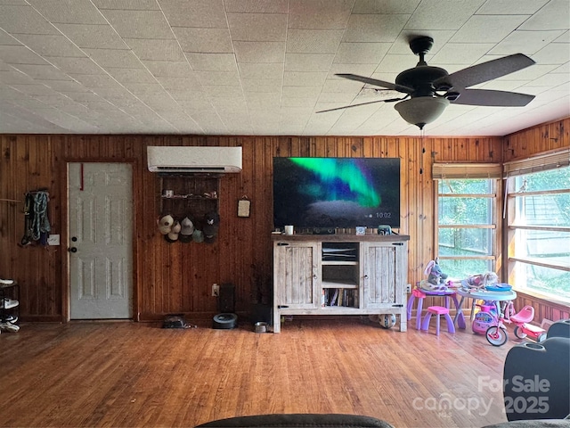 140 Wallins Way, Mars Hill, NC 28754 - living area featuring a wall unit AC, wooden walls, a ceiling fan, and wood finished floors