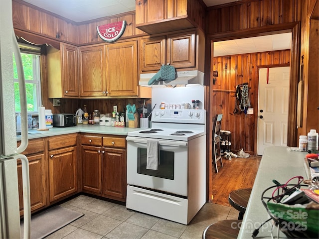 140 Wallins Way, Mars Hill, NC 28754 - kitchen with white electric range oven, extractor fan, wood walls, light countertops, and light tile patterned flooring