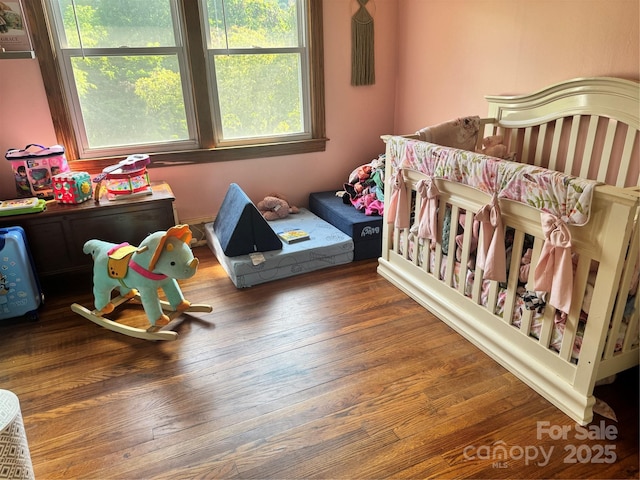 140 Wallins Way, Mars Hill, NC 28754 - bedroom featuring wood finished floors and a crib