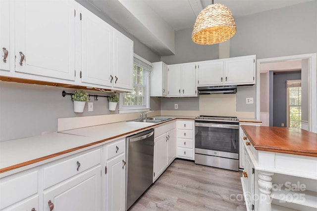 7017 Brookgreen Ter, Matthews, NC 28104 - kitchen with appliances with stainless steel finishes, white cabinets, under cabinet range hood, and light wood-style flooring