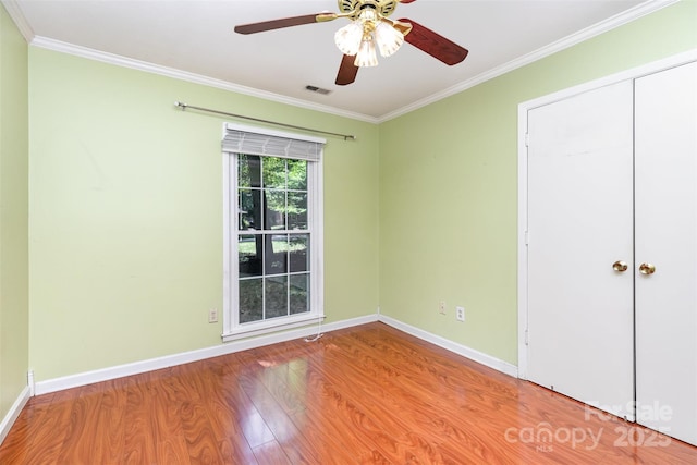 7017 Brookgreen Ter, Matthews, NC 28104 - unfurnished bedroom featuring wood finished floors, crown molding, a closet, and ceiling fan