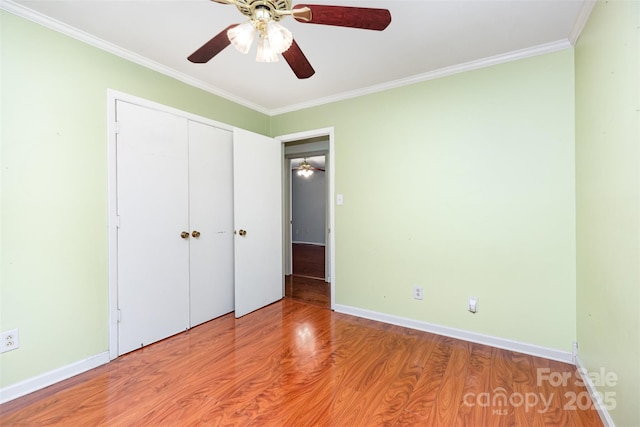 7017 Brookgreen Ter, Matthews, NC 28104 - unfurnished bedroom with wood finished floors, crown molding, a closet, and a ceiling fan