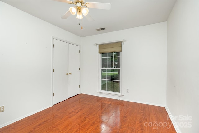 7017 Brookgreen Ter, Matthews, NC 28104 - unfurnished bedroom with wood finished floors, a closet, and a ceiling fan