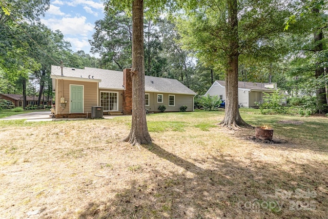 7017 Brookgreen Ter, Matthews, NC 28104 - back of house with a fire pit, a lawn, an outdoor structure, and view of wooded area
