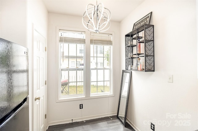 8424 Spirea Ct, Charlotte, NC 28215 - unfurnished dining area with a chandelier and wood finished floors