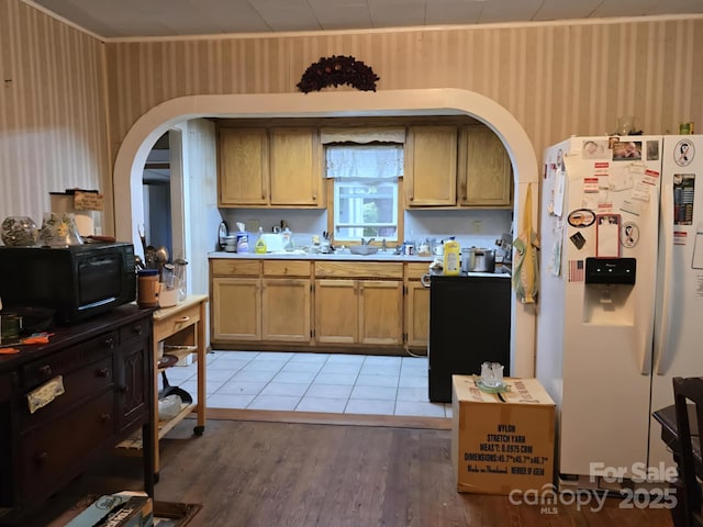 7601 Rhodhiss Rd, Connelly Springs, NC 28612 - kitchen with white refrigerator with ice dispenser, arched walkways, wallpapered walls, light wood-type flooring, and light countertops