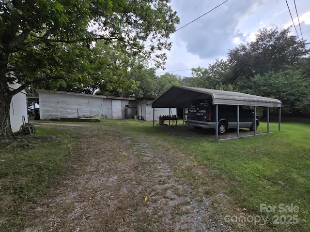 7601 Rhodhiss Rd, Connelly Springs, NC 28612 - view of green lawn with a carport and driveway