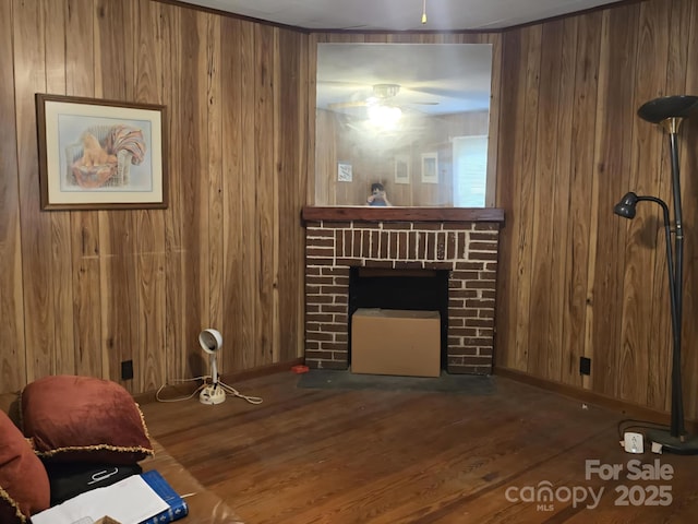 7601 Rhodhiss Rd, Connelly Springs, NC 28612 - living area with a fireplace, wood walls, wood finished floors, and a ceiling fan