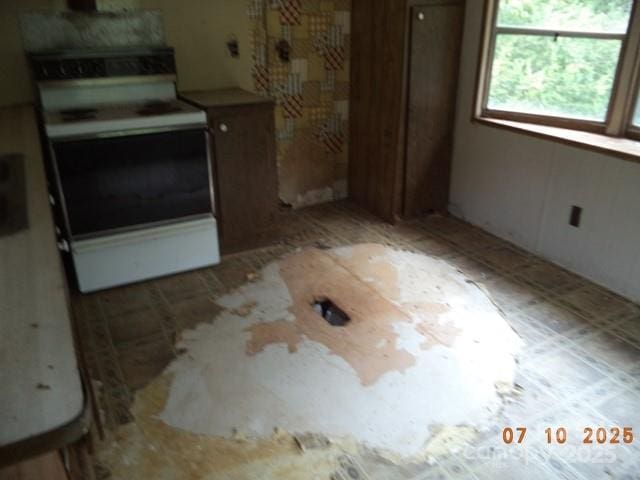 1374 Circle Dr, China Grove, NC 28023 - kitchen with electric range and brown cabinetry