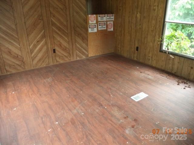 1374 Circle Dr, China Grove, NC 28023 - unfurnished room featuring wood-type flooring and wood walls